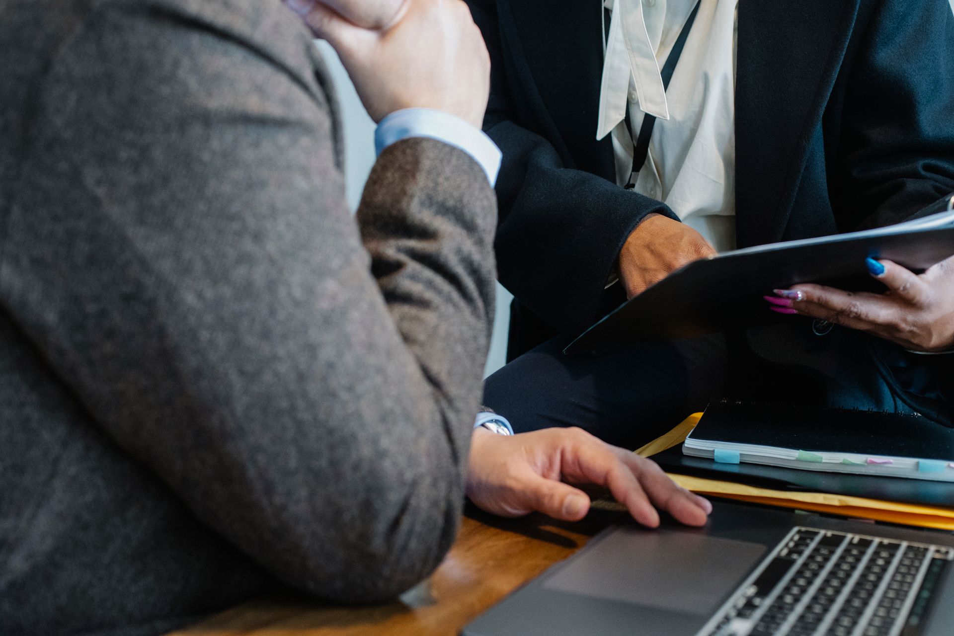 Two professionals reviewing financial documents together